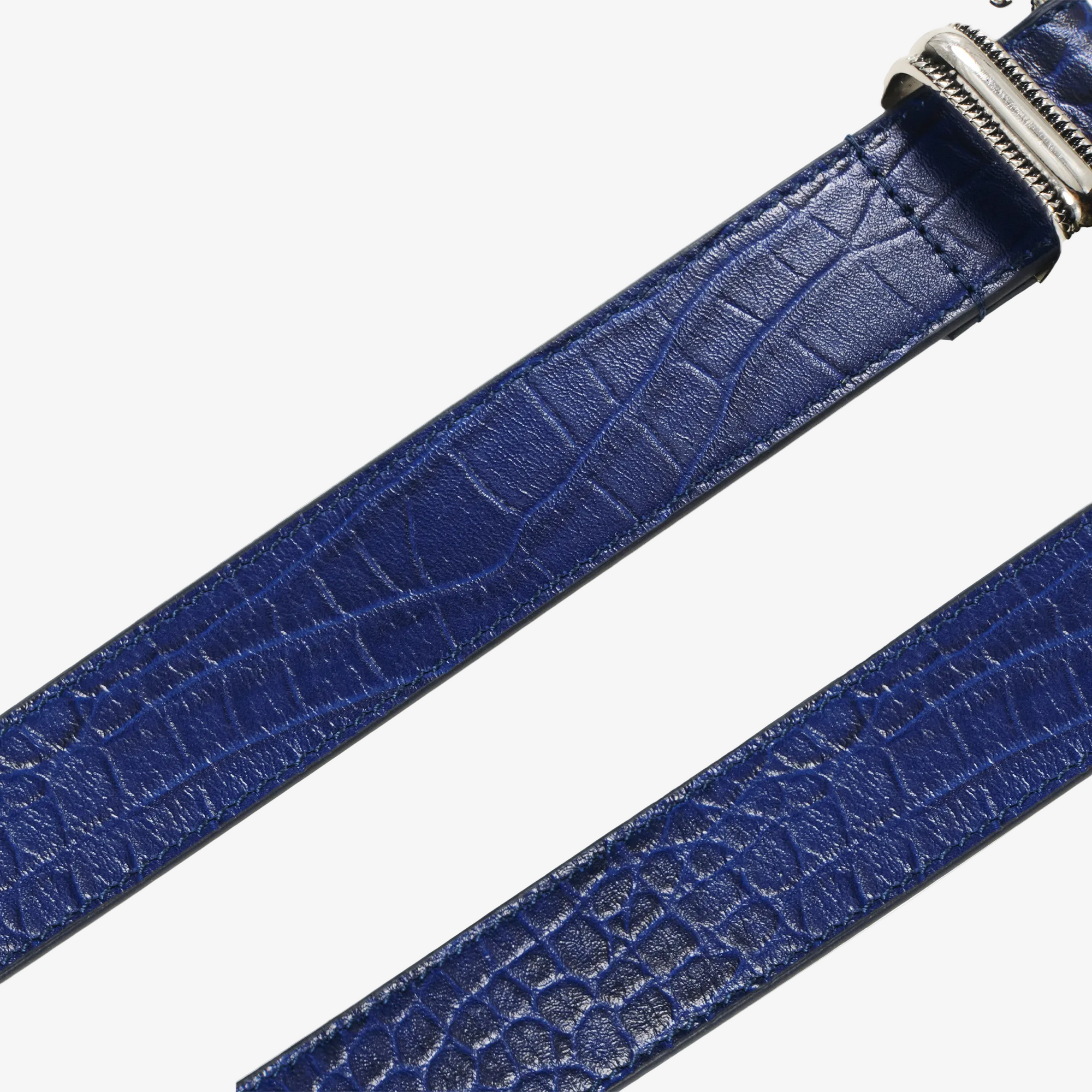 Detailed shot of Blue croc textured belt with a silver buckle on a white background