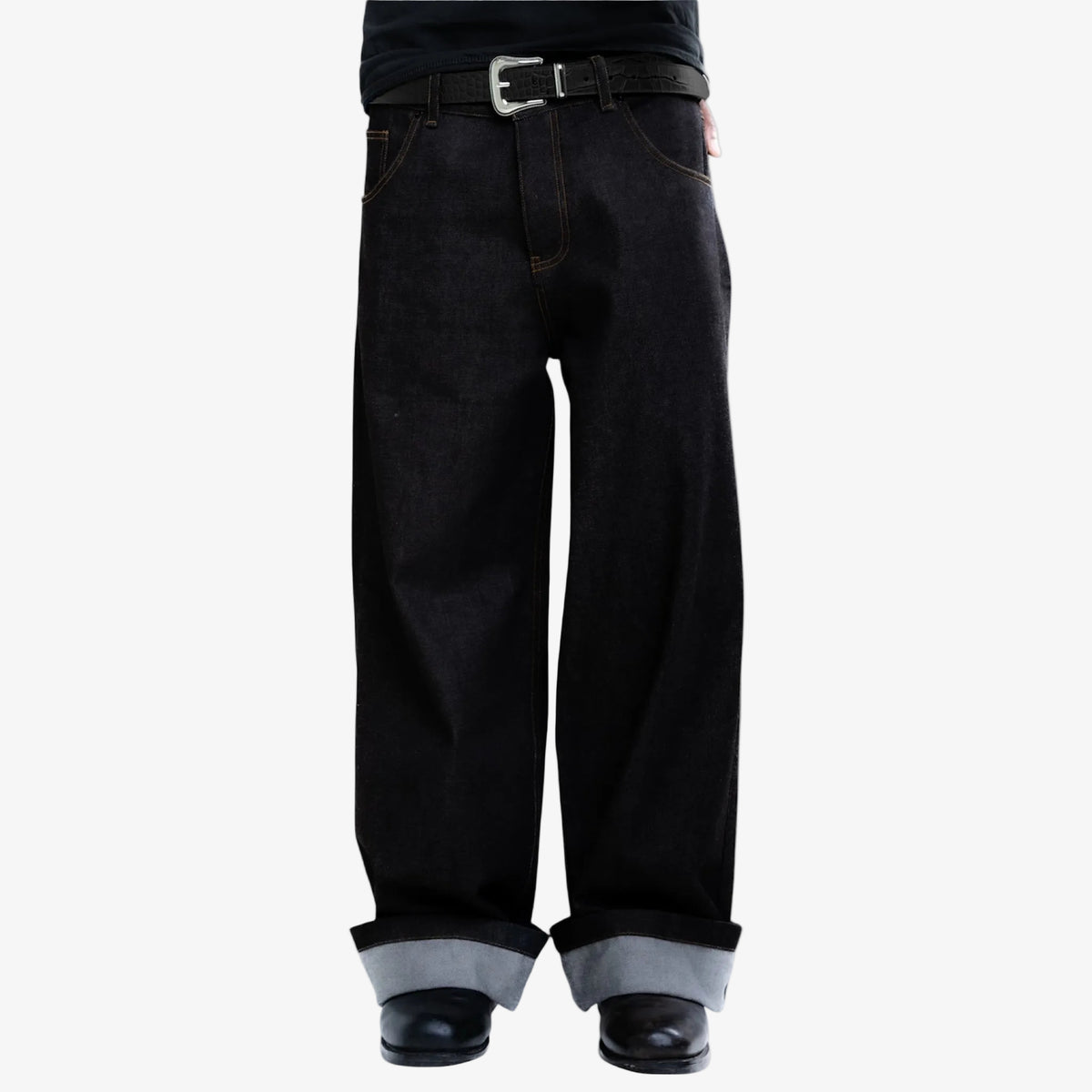 Black jeans with rolled-up cuffs  and black embossed belt on a white background