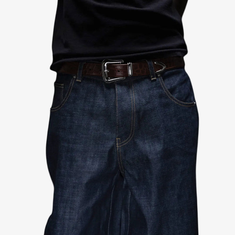 Dark blue jeans with a brown belt on a white background