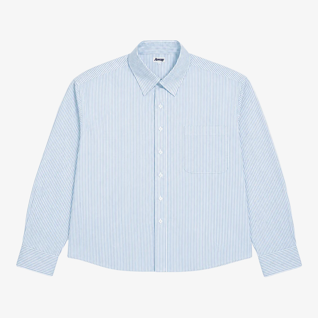 A light blue and white vertically striped long-sleeve button-up shirt with a single chest pocket, laid flat against a light gray background.