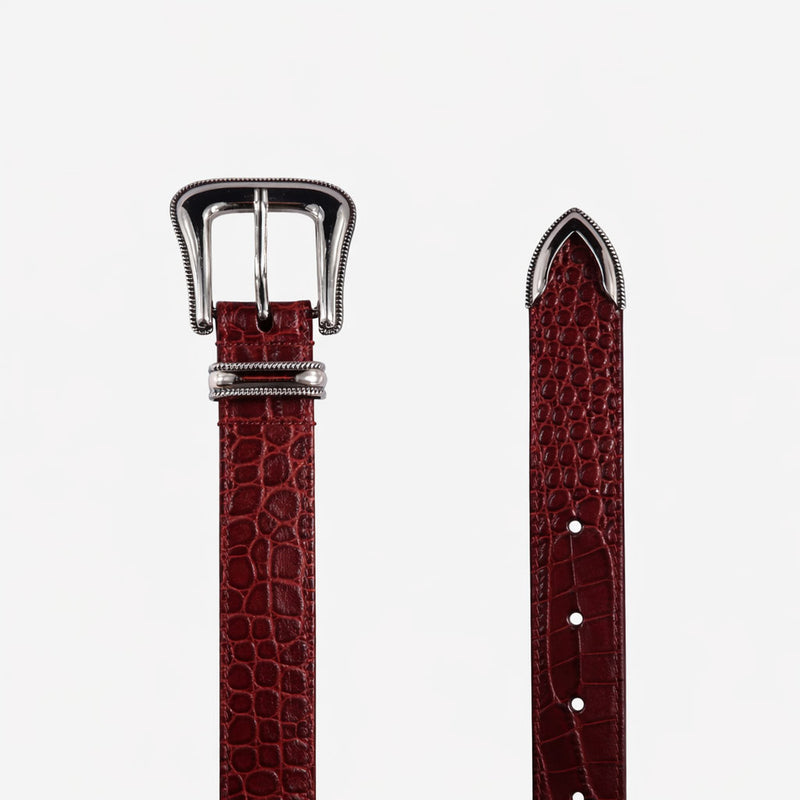 Red leather belt with silver buckle on a white background