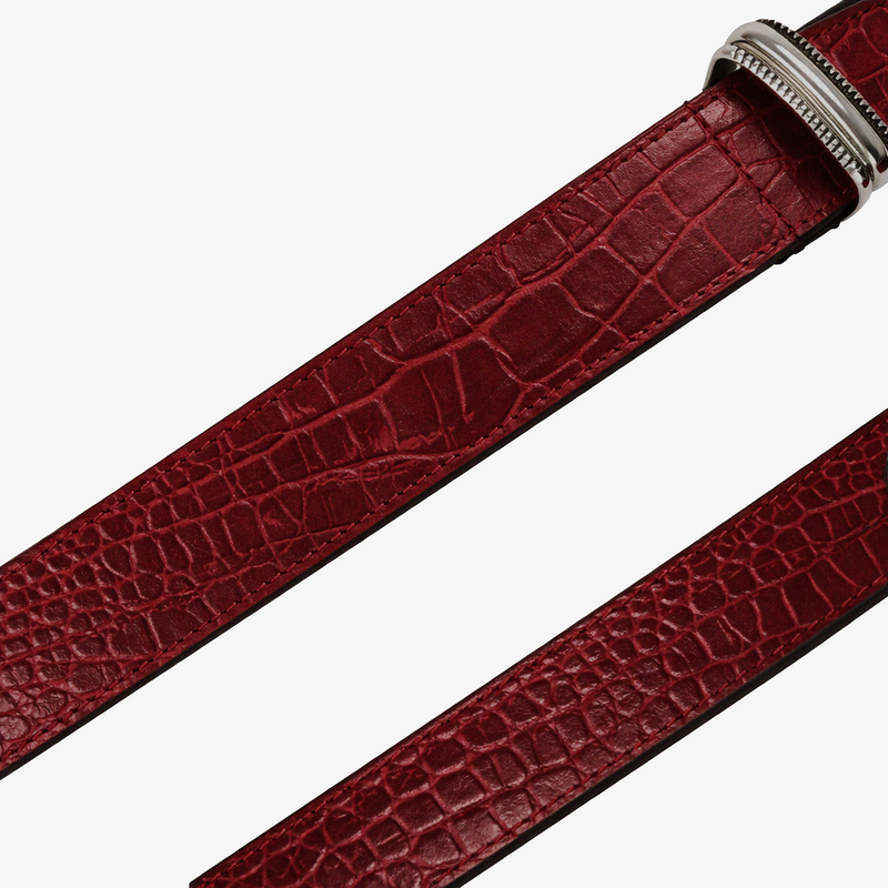 Detail Red leather belt with a silver buckle on a white background